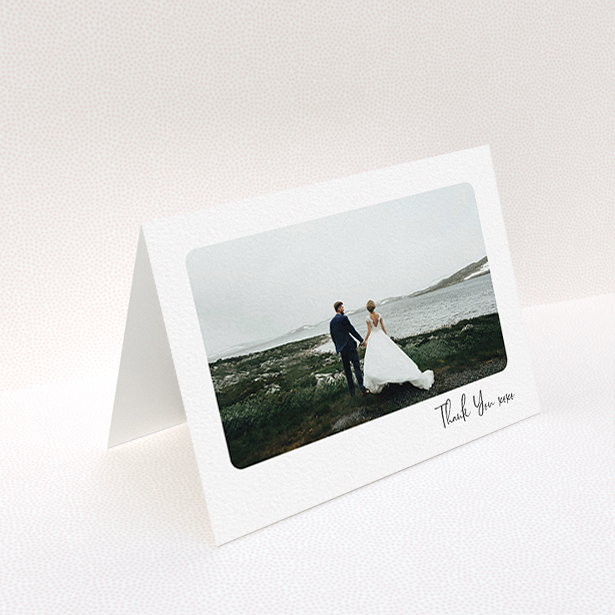 A wedding thank you card design titled "Rounded Thanks". It is an A6 card in a landscape orientation. It is a photographic wedding thank you card with room for 1 photo. "Rounded Thanks" is available as a folded card, with mainly white colouring.