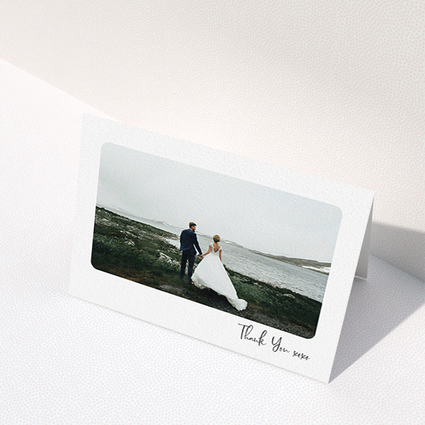A wedding thank you card design titled "Rounded Thanks". It is an A6 card in a landscape orientation. It is a photographic wedding thank you card with room for 1 photo. "Rounded Thanks" is available as a folded card, with mainly white colouring.