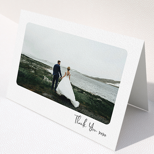 A wedding thank you card design titled "Rounded Thanks". It is an A6 card in a landscape orientation. It is a photographic wedding thank you card with room for 1 photo. "Rounded Thanks" is available as a folded card, with mainly white colouring.