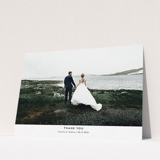 A wedding thank you card design named "Sans Serif". It is an A6 card in a landscape orientation. It is a photographic wedding thank you card with room for 1 photo. "Sans Serif" is available as a flat card, with mainly white colouring.