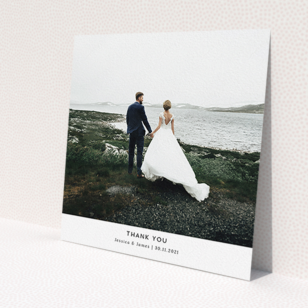 A wedding thank you card called 'Sans Serif'. It is a square (148mm x 148mm) card in a square orientation. It is a photographic wedding thank you card with room for 1 photo. 'Sans Serif' is available as a flat card, with mainly white colouring.