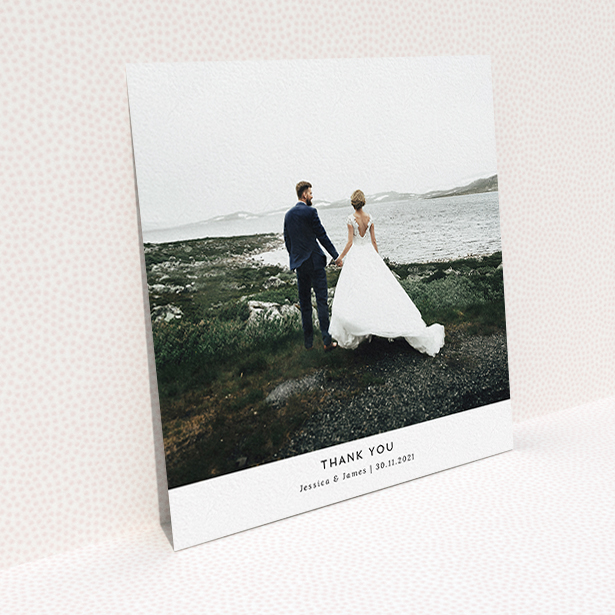 A wedding thank you card called "Sans Serif". It is a square (148mm x 148mm) card in a square orientation. It is a photographic wedding thank you card with room for 1 photo. "Sans Serif" is available as a flat card, with mainly white colouring.