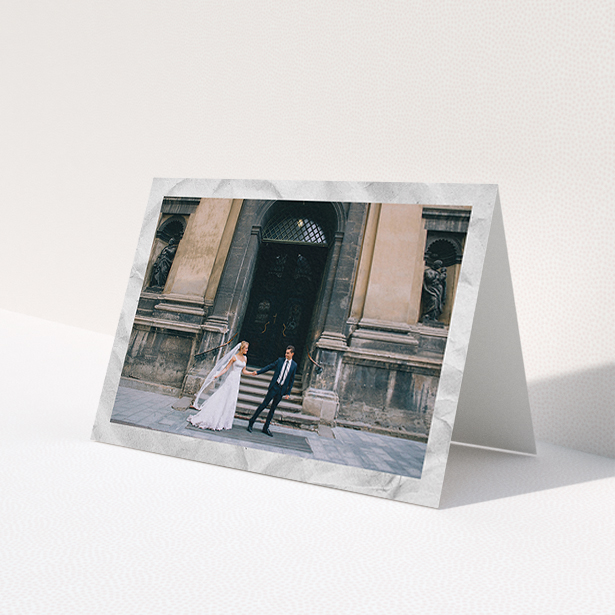 A wedding thank you card called 'Sat on Marble'. It is an A6 card in a landscape orientation. It is a photographic wedding thank you card with room for 1 photo. 'Sat on Marble' is available as a folded card, with mainly white colouring.