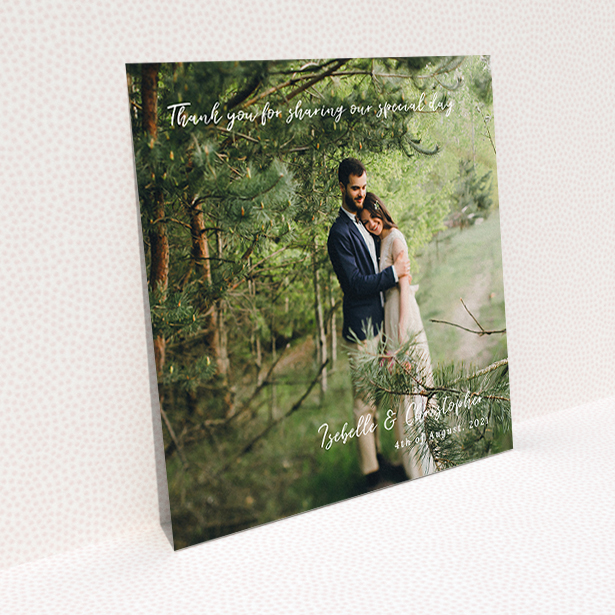 A wedding thank you card template titled "Scripted". It is a square (148mm x 148mm) card in a square orientation. It is a photographic wedding thank you card with room for 1 photo. "Scripted" is available as a flat card, with mainly white colouring.