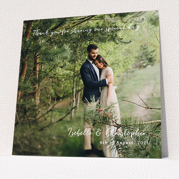 A wedding thank you card template titled "Scripted". It is a square (148mm x 148mm) card in a square orientation. It is a photographic wedding thank you card with room for 1 photo. "Scripted" is available as a flat card, with mainly white colouring.