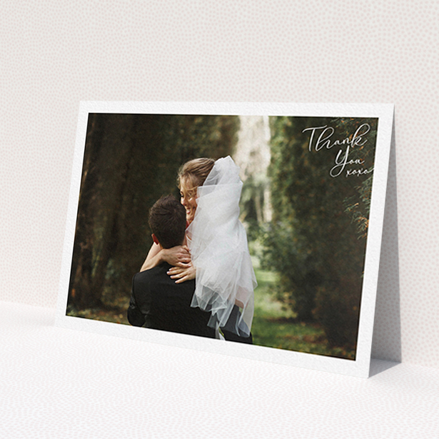 A wedding thank you card design named 'Simple Landscape Thanks'. It is an A6 card in a landscape orientation. It is a photographic wedding thank you card with room for 1 photo. 'Simple Landscape Thanks' is available as a flat card, with mainly white colouring.