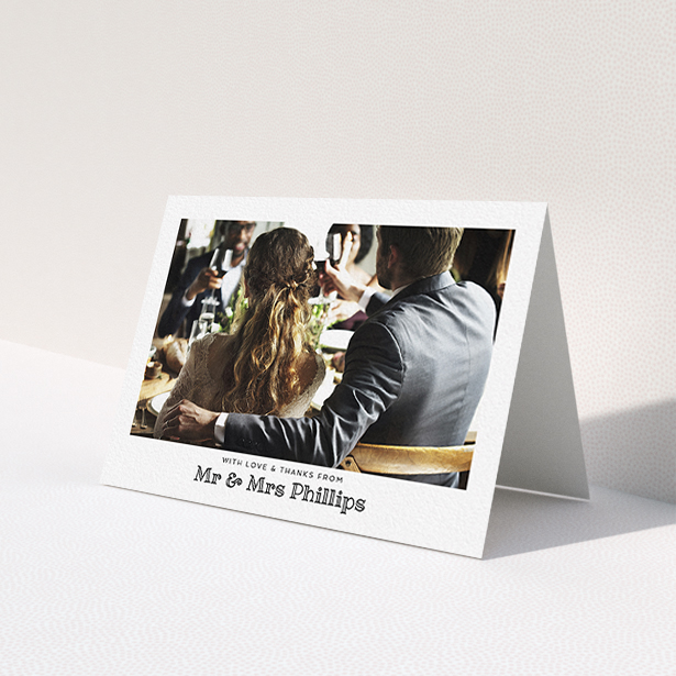 A wedding thank you card template titled 'Simple Photo Frame'. It is an A6 card in a landscape orientation. It is a photographic wedding thank you card with room for 1 photo. 'Simple Photo Frame' is available as a folded card, with mainly white colouring.