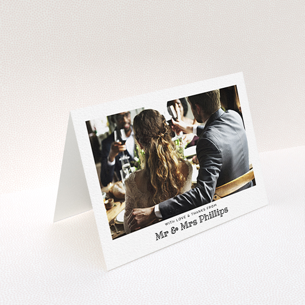 A wedding thank you card template titled "Simple Photo Frame". It is an A6 card in a landscape orientation. It is a photographic wedding thank you card with room for 1 photo. "Simple Photo Frame" is available as a folded card, with mainly white colouring.