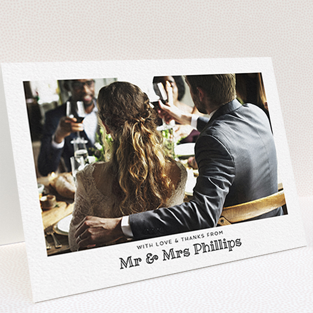 A wedding thank you card template titled "Simple Photo Frame". It is an A6 card in a landscape orientation. It is a photographic wedding thank you card with room for 1 photo. "Simple Photo Frame" is available as a folded card, with mainly white colouring.
