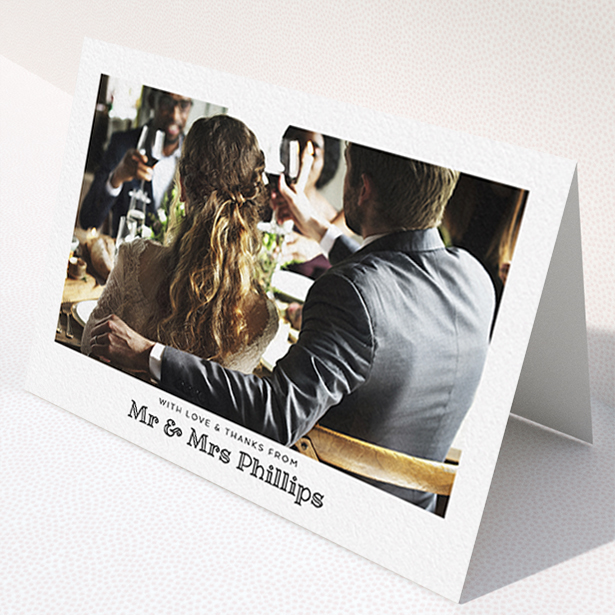A wedding thank you card template titled "Simple Photo Frame". It is an A6 card in a landscape orientation. It is a photographic wedding thank you card with room for 1 photo. "Simple Photo Frame" is available as a folded card, with mainly white colouring.