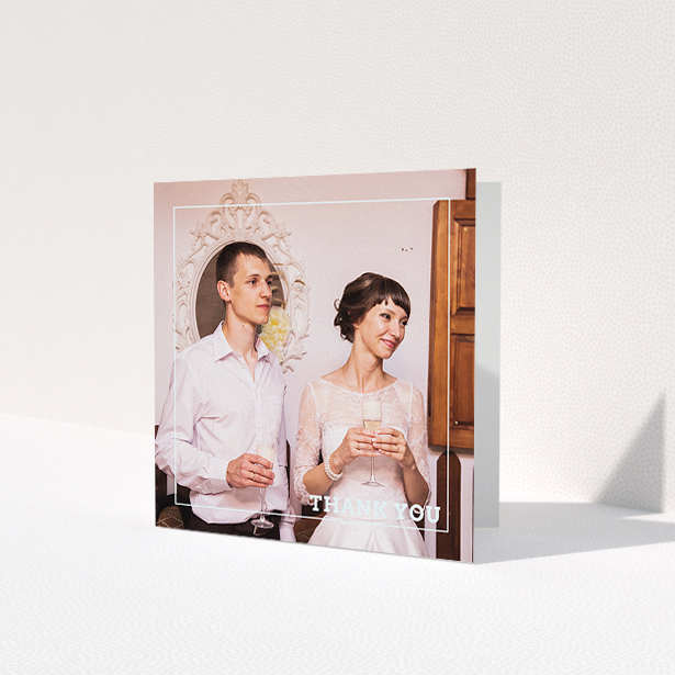 A wedding thank you card design titled 'Simple Thank You Frame'. It is a square (148mm x 148mm) card in a square orientation. It is a photographic wedding thank you card with room for 1 photo. 'Simple Thank You Frame' is available as a folded card, with mainly white colouring.