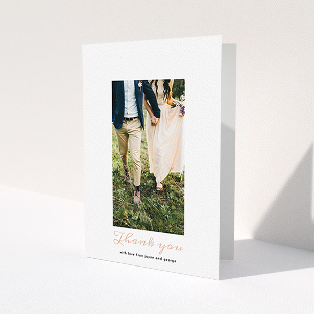A wedding thank you card template titled 'Small and Central'. It is an A6 card in a portrait orientation. It is a photographic wedding thank you card with room for 1 photo. 'Small and Central' is available as a folded card, with tones of white and pink.