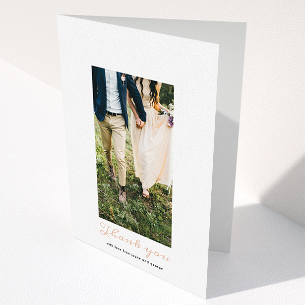 A wedding thank you card template titled "Small and Central". It is an A6 card in a portrait orientation. It is a photographic wedding thank you card with room for 1 photo. "Small and Central" is available as a folded card, with tones of white and pink.