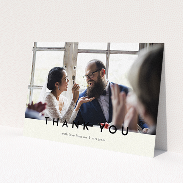 A wedding thank you card named 'Split thank you '. It is an A6 card in a landscape orientation. It is a photographic wedding thank you card with room for 1 photo. 'Split thank you ' is available as a flat card, with mainly cream colouring.