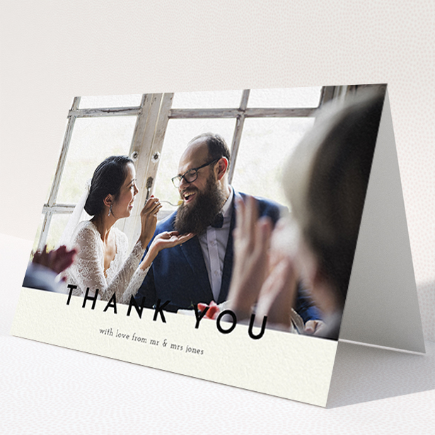A wedding thank you card design titled "Split thank you ". It is an A6 card in a landscape orientation. It is a photographic wedding thank you card with room for 1 photo. "Split thank you " is available as a folded card, with mainly cream colouring.