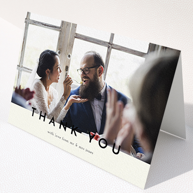A wedding thank you card design titled "Split thank you ". It is an A6 card in a landscape orientation. It is a photographic wedding thank you card with room for 1 photo. "Split thank you " is available as a folded card, with mainly cream colouring.