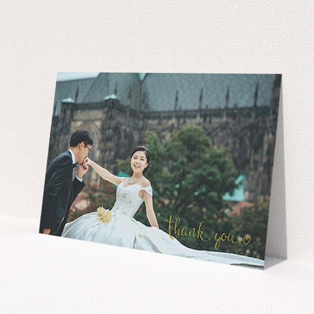 A wedding thank you card called 'Thank you with a heart'. It is an A6 card in a landscape orientation. It is a photographic wedding thank you card with room for 1 photo. 'Thank you with a heart' is available as a flat card, with mainly gold colouring.