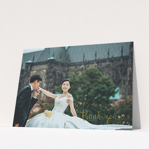 A wedding thank you card called "Thank you with a heart". It is an A6 card in a landscape orientation. It is a photographic wedding thank you card with room for 1 photo. "Thank you with a heart" is available as a flat card, with mainly gold colouring.