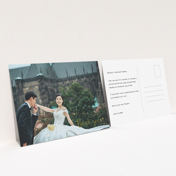 A wedding thank you card called "Thank you with a heart". It is an A6 card in a landscape orientation. It is a photographic wedding thank you card with room for 1 photo. "Thank you with a heart" is available as a flat card, with mainly gold colouring.
