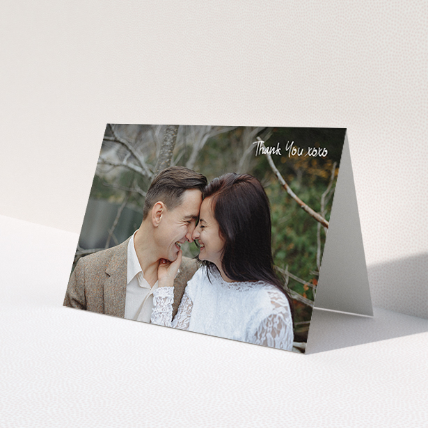 A wedding thank you card design named 'Thank You XOXO'. It is an A6 card in a landscape orientation. It is a photographic wedding thank you card with room for 1 photo. 'Thank You XOXO' is available as a folded card, with mainly white colouring.