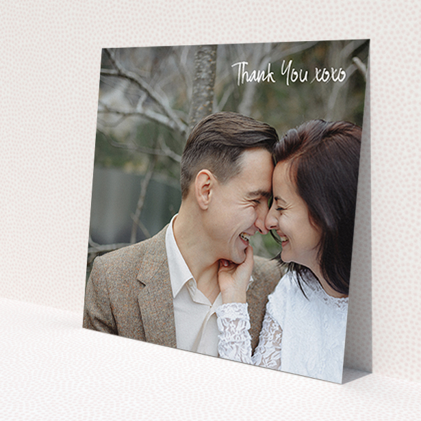 A wedding thank you card design called 'Thank You XOXO'. It is a square (148mm x 148mm) card in a square orientation. It is a photographic wedding thank you card with room for 1 photo. 'Thank You XOXO' is available as a flat card, with mainly white colouring.