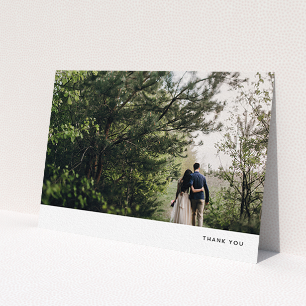 A wedding thank you card called 'Thankful with Simplicity'. It is an A6 card in a landscape orientation. It is a photographic wedding thank you card with room for 1 photo. 'Thankful with Simplicity' is available as a flat card, with mainly white colouring.