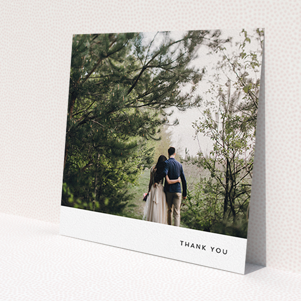 A wedding thank you card design titled 'Thankful with Simplicity'. It is a square (148mm x 148mm) card in a square orientation. It is a photographic wedding thank you card with room for 1 photo. 'Thankful with Simplicity' is available as a flat card, with mainly white colouring.