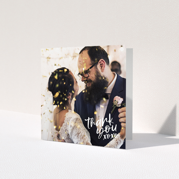 A wedding thank you card template titled 'Thanks In the Corner'. It is a square (148mm x 148mm) card in a square orientation. It is a photographic wedding thank you card with room for 1 photo. 'Thanks In the Corner' is available as a folded card, with mainly white colouring.