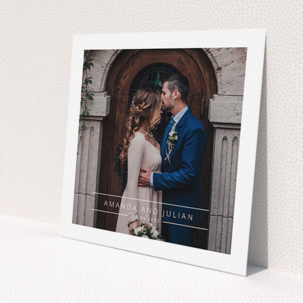 A wedding thank you card design titled 'Tramlines'. It is a square (148mm x 148mm) card in a square orientation. It is a photographic wedding thank you card with room for 1 photo. 'Tramlines' is available as a flat card, with mainly white colouring.