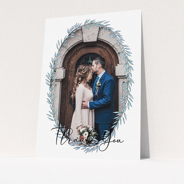A wedding thank you card design called "Tussled Wreath Frame". It is an A5 card in a portrait orientation. It is a photographic wedding thank you card with room for 1 photo. "Tussled Wreath Frame" is available as a flat card, with mainly blue colouring.