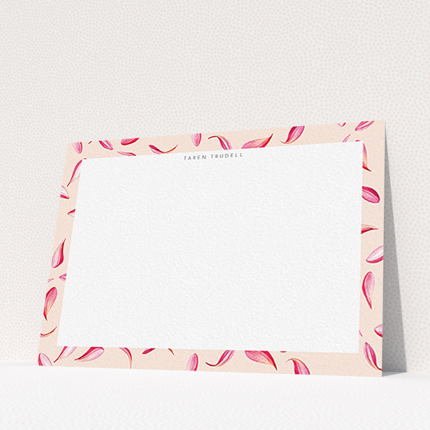 A womens correspondence card design titled "Petal confetti". It is an A6 card in a landscape orientation. "Petal confetti" is available as a flat card, with tones of pink, red and white.
