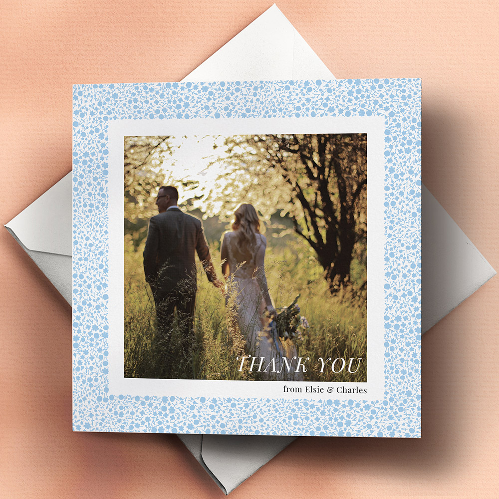 A blue and white, square traditional wedding thank you card with a colourful style.