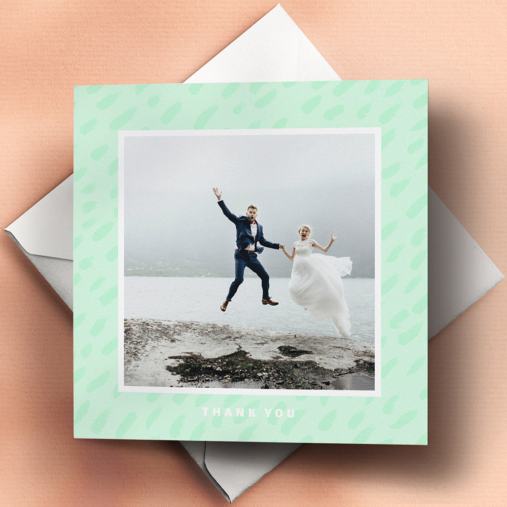 A green and white, square folded wedding thank you card with a modern style.