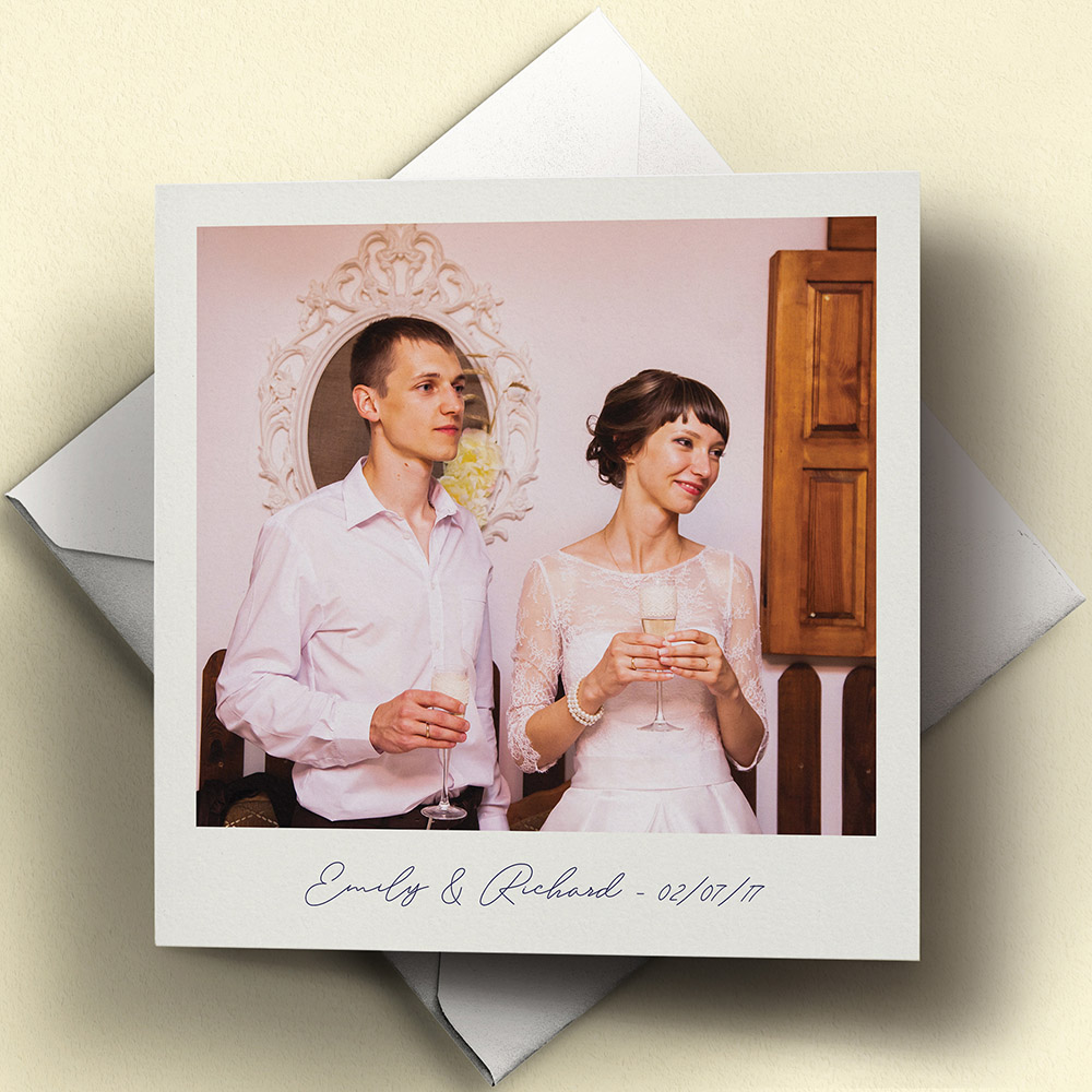 A white and navy blue, square folded wedding thank you card with a rustic style.