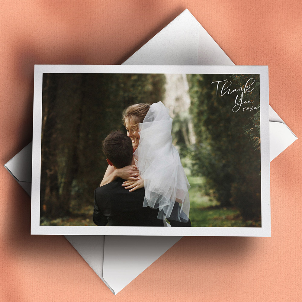 A white, a5 landscape folded wedding thank you card with a traditional style.