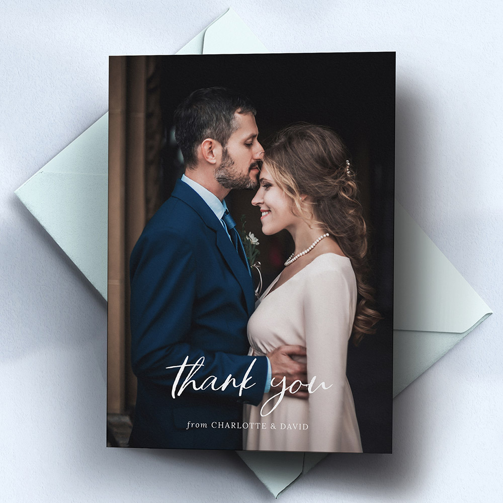 A white, a5 portrait wedding thank you card with photos with a vintage style.