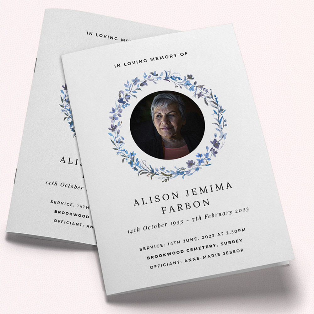 A white and light blue, a5 portrait funeral programme with an elegant style.