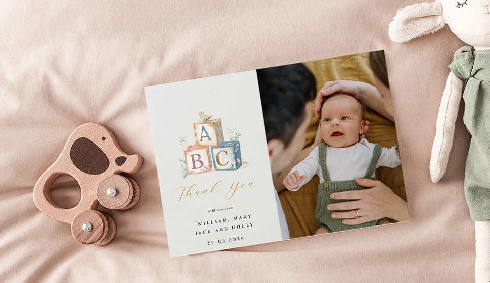 Baby-themed thank you card with wooden toys and soft accents