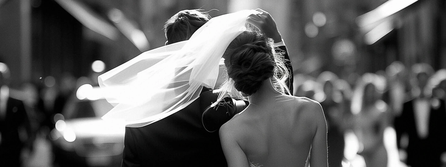 Black and white photo capturing a romantic wedding moment with elegance and style