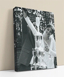 Black and white photo canvas of a couple pouring champagne tower