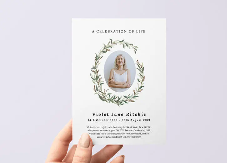 Elegant funeral announcement card featuring a floral wreath and personalised memorial details