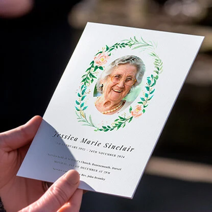 Funeral order of service card with a floral design and photo of the loved one