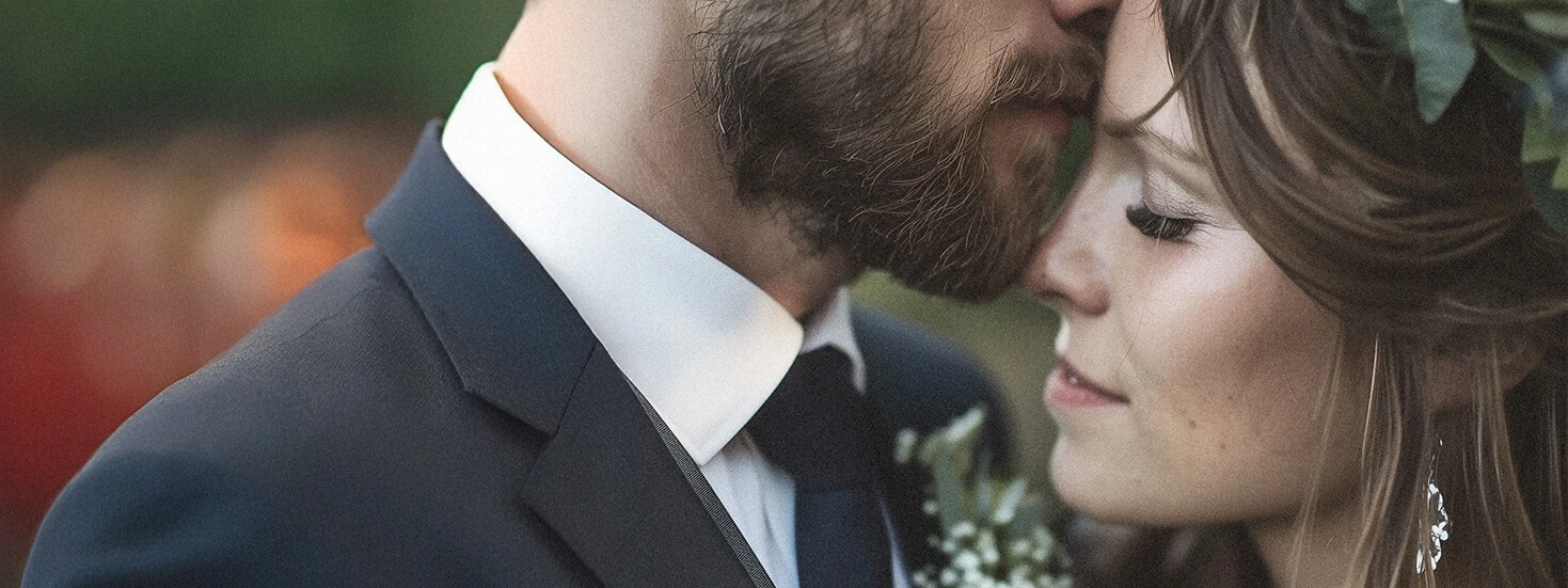 Closeup of a bride and groom embracing, showcasing love and elegance on their wedding day