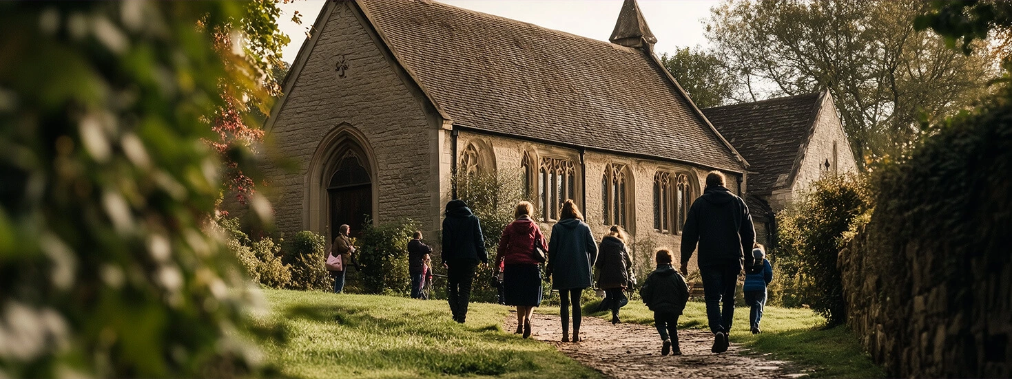 Family walking towards a countryside church for a communion service.