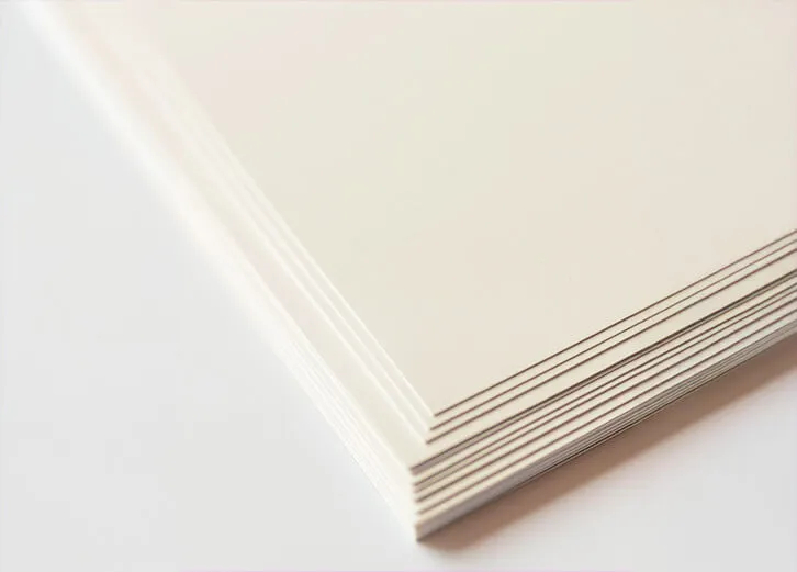 Close-up of a neatly stacked pile of premium card sheets with a textured finish for eco-conscious use