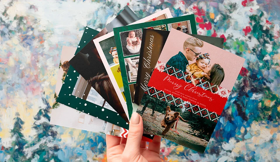 Festive photo card designs printed on premium cards and held up together