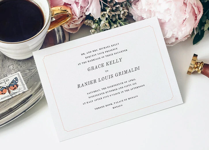 Vintage-inspired save-the-date card with elegant typography and floral arrangements