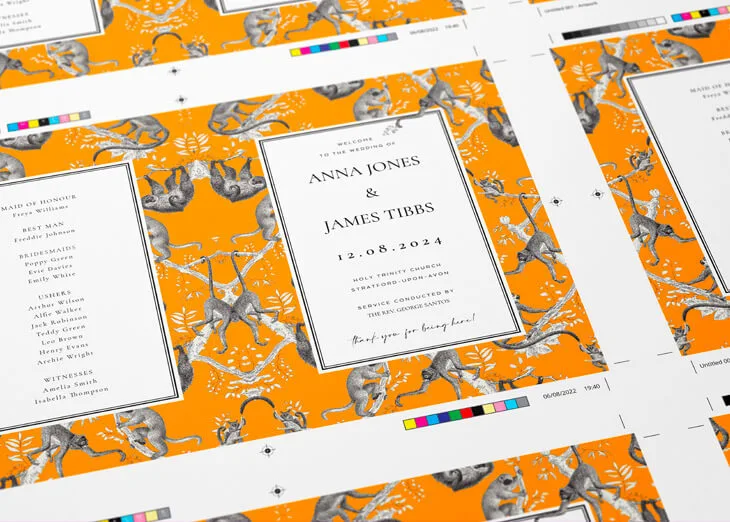 Printed proof of wedding stationery with vibrant orange designs and layout details for review