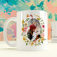 White ceramic custom mug featuring a floral frame and personalised photo, professionally printed by Utterly Printable.