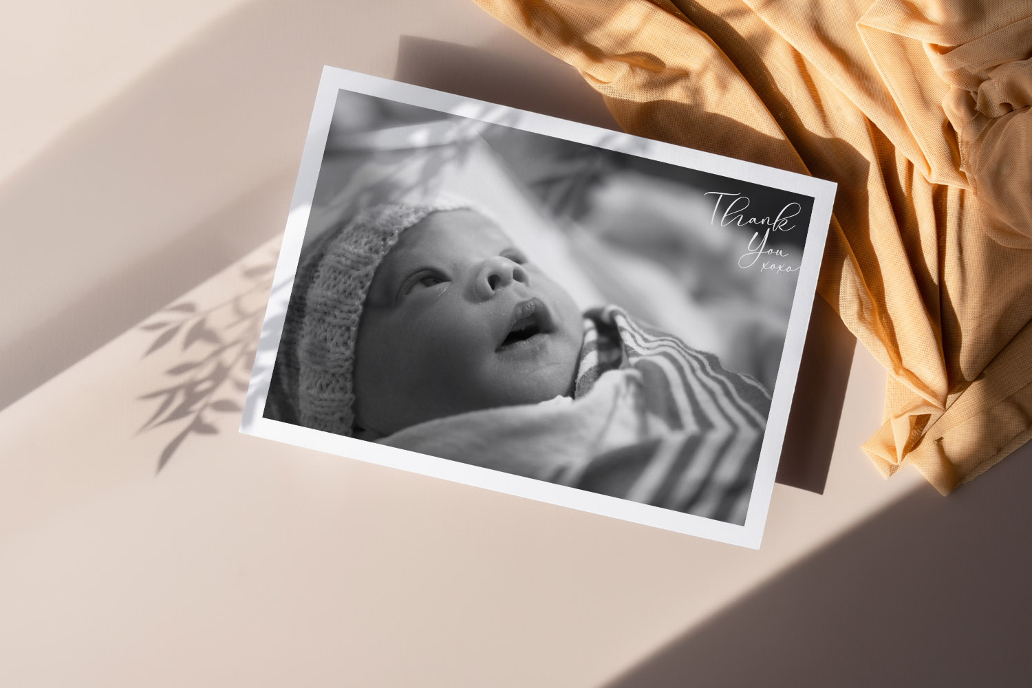 Baby thank you cards featuring a black and white newborn photo with handwritten thank you text, displayed on a neutral